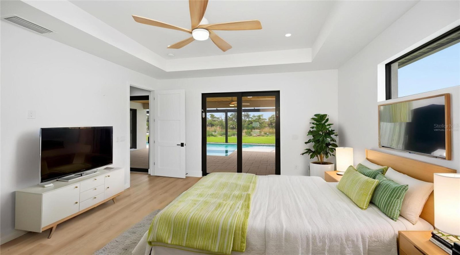 Virtually Staged Primary Suite With Direct Pool Access.
