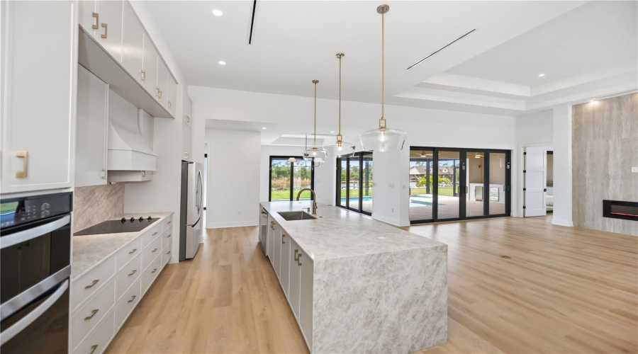 Kitchen Features Quartz Countertops, Waterfall Island, And Premium Appliances.