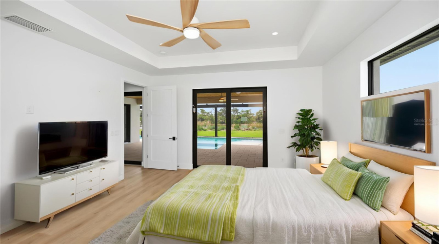 Virtually Staged Primary Suite With Pool Access And Serene Preserve Views.
