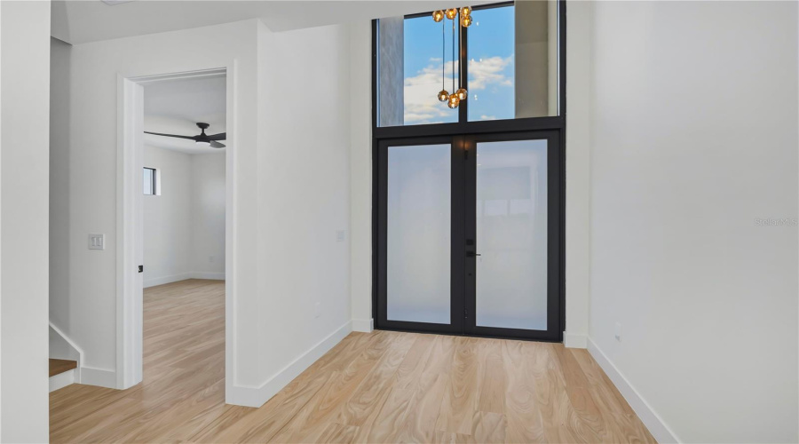 Grand Entryway With Soaring Glass Accent Window.