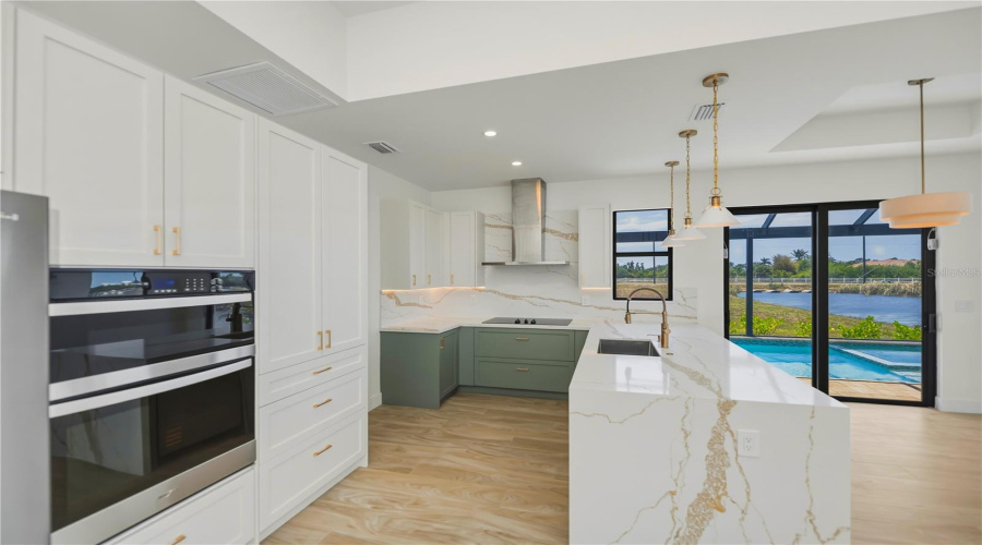 Designer Kitchen With Waterfall Quartz Island.