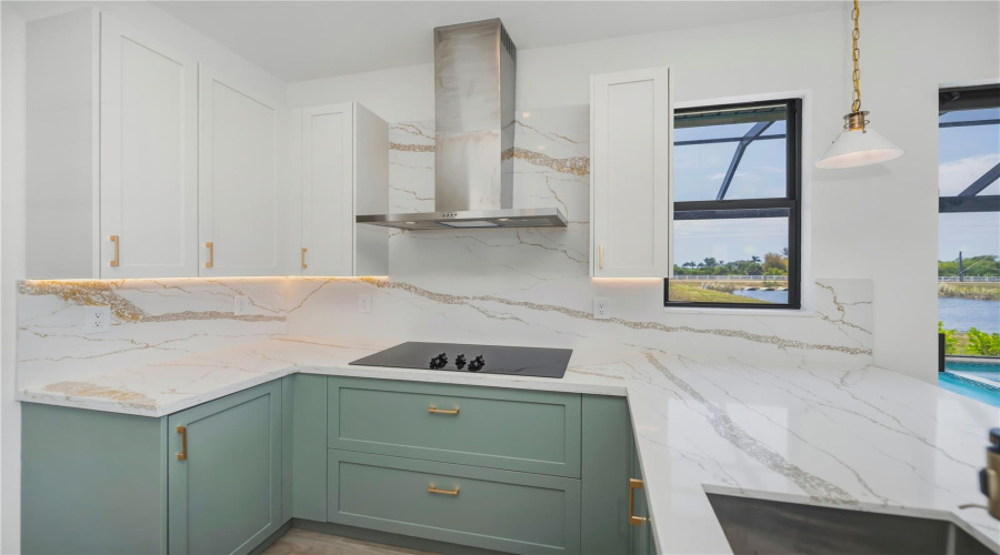 Quartz Counters, Backsplash, Custom Lighting And Coastal Cabinetry.