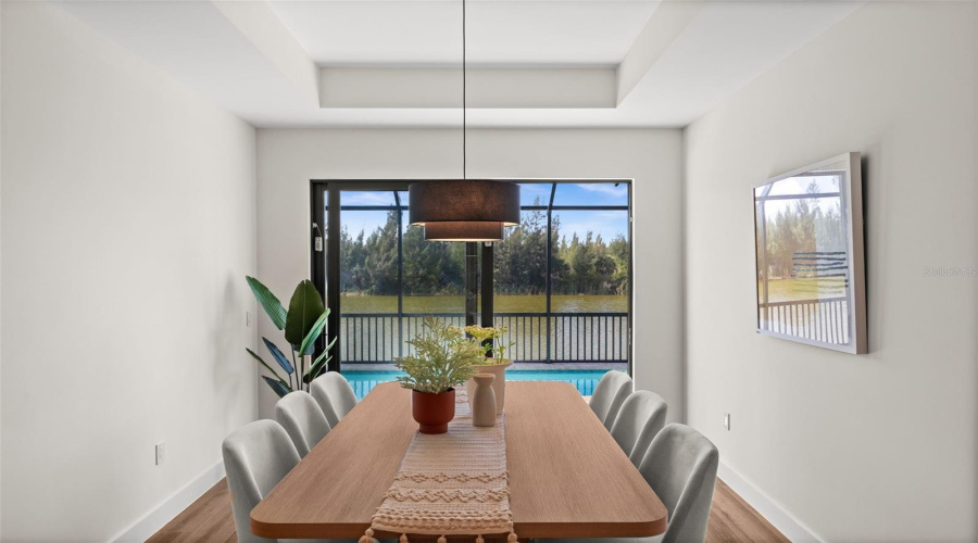 Dining Room With Direct Pool Access And Tray Ceiling.