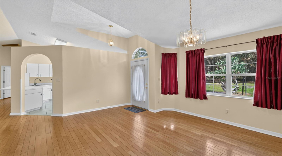 Bright, Open Interior With Vaulted Ceiling And Wood Floors.