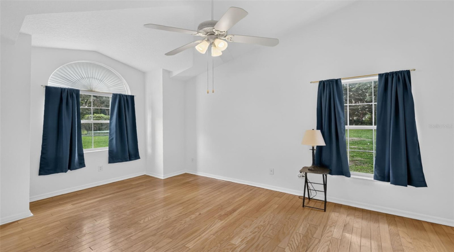 Primary Suite 1 With Wood Floors And Walk-In Closet.