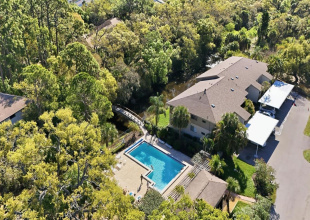 Gorgeous First floor Condominium steps from the heated Pool, overlooking a private footbridge and Crooked Creek
