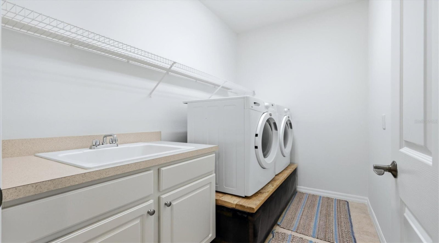 Oversized Inside Utility Room With Sink And Raised Washer/Dryer