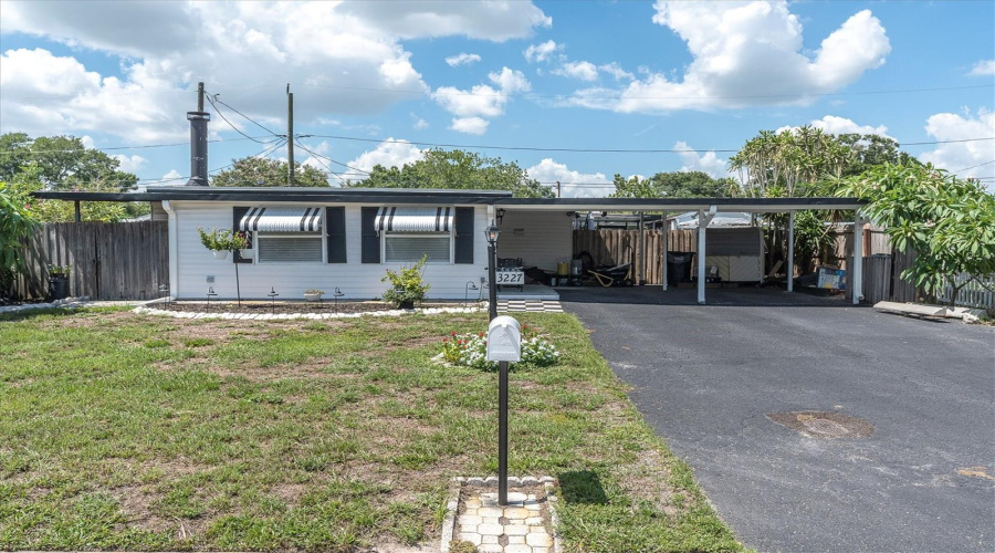 Front Exterior With Oversized Driveway And Carport