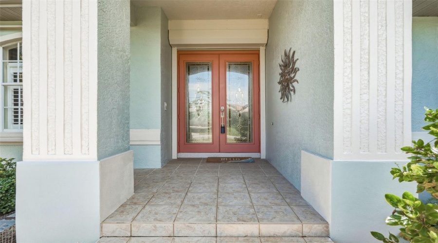 Welcoming Covered Front Entry With Leaded Glass Double Doors