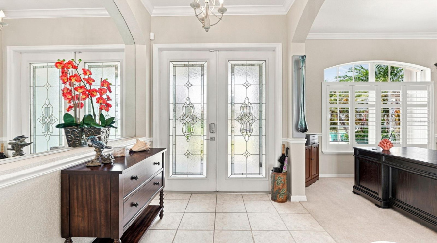 Grand Foyer With Abundant Natural Light Crown Molding