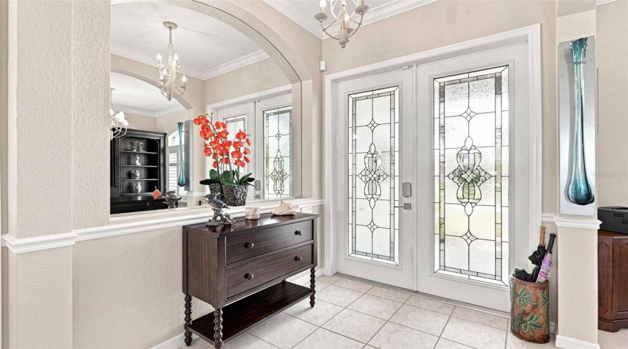 Sophisticated Entryway With Decorative Glass Double Doors