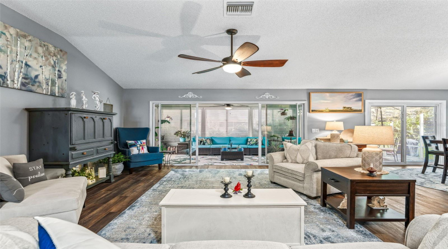Large Windows And Sliding Glass Doors Brighten The Main Living Area While Providing A Pleasant View Toward The Enclosed Rear Living Space.
