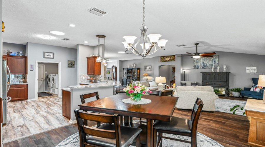 The Centrally Located Dining Area Offers An Easy Flow To The Kitchen And Living Room, Creating A Comfortable Setting For Meals And Entertaining.