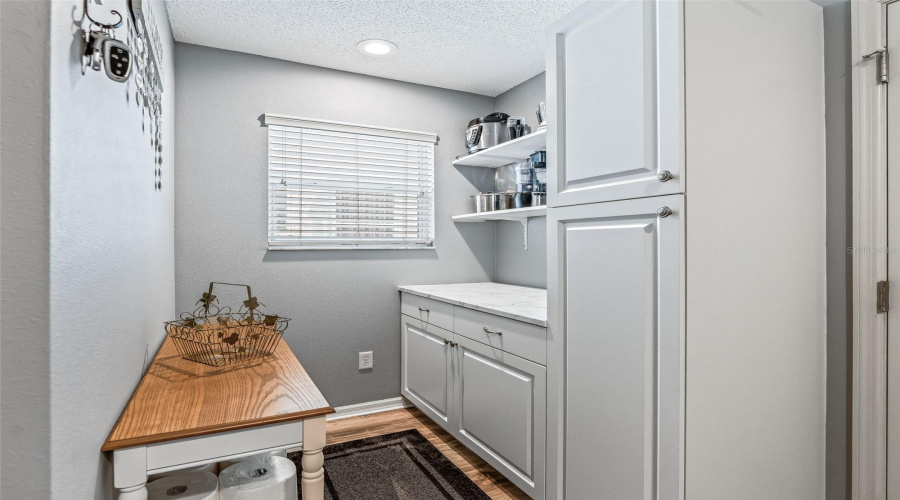 Additional Built-In Cabinetry, Open Shelving, And A Convenient Bench Provide Excellent Organization And Functional Workspace Within The Laundry Room.