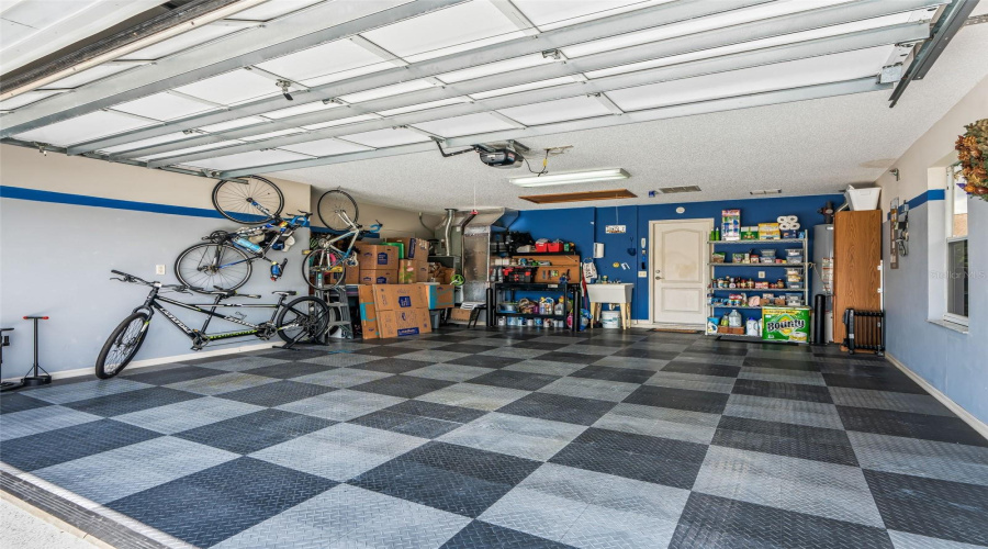 Clean, Oversized Garage Offers Abundant Storage Space, Wall-Mounted Organization, And Durable Interlocking Floor Tiles For A Polished, Easy-Care Finish. (Clean Floor Underneath!)