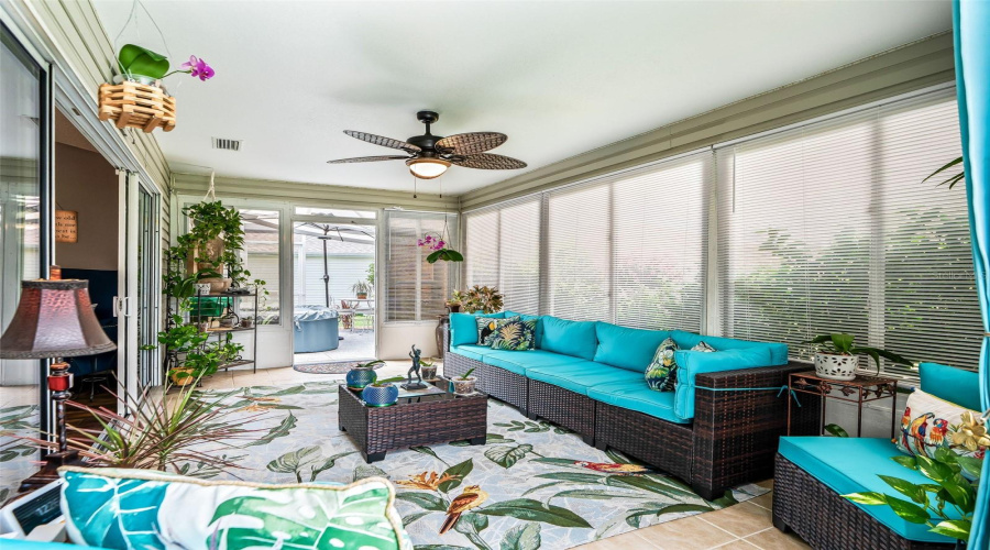 This Inviting Indoor-Outdoor Living Space Features Abundant Natural Light, Screened Privacy Panels, And A Flexible Layout For Conversation, Reading, Or Casual Gatherings.