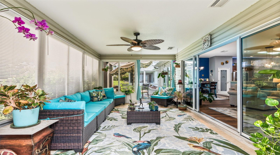 The Enclosed Lanai Offers A Long, Versatile Layout With Multiple Seating Areas, Sliding-Glass Access To The Home, And A Seamless Connection To The Outdoor Spa And Eating Areas.