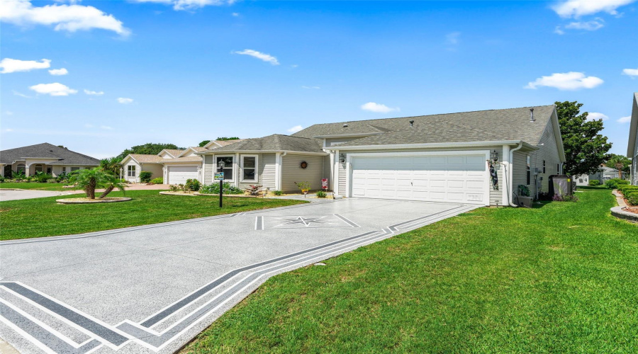 Wide Custom Painted Driveway, Manicured Lawn, And Attractive Side Elevation Enhance The Home’s Curb Appeal And Provide A Spacious, Open Feel.