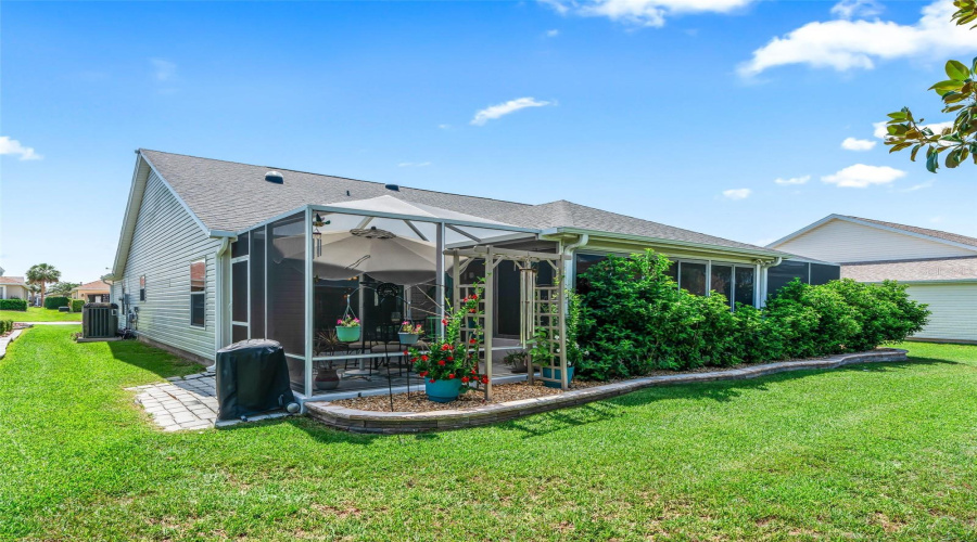 A Screened Lanai, Shaded Patio, And Attractive Garden Borders Extend The Home’s Living Space Into The Outdoors.