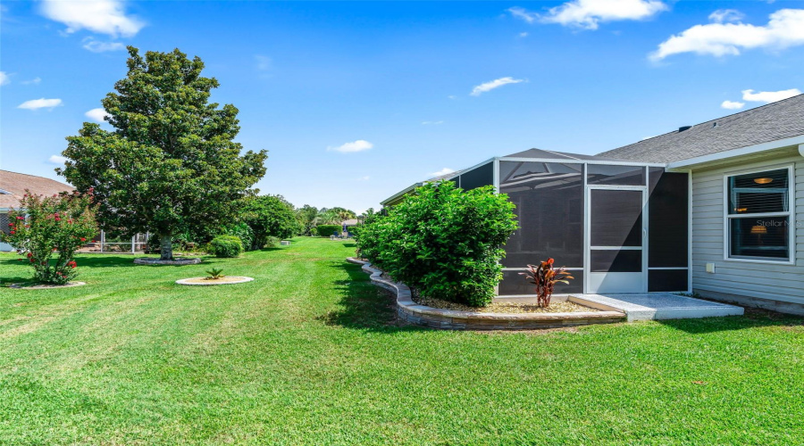 A Wide Lawn, Mature Shade Tree, And Environment With An Open, Uncrowded Feelscreened Lanai Create A Peaceful Backyard