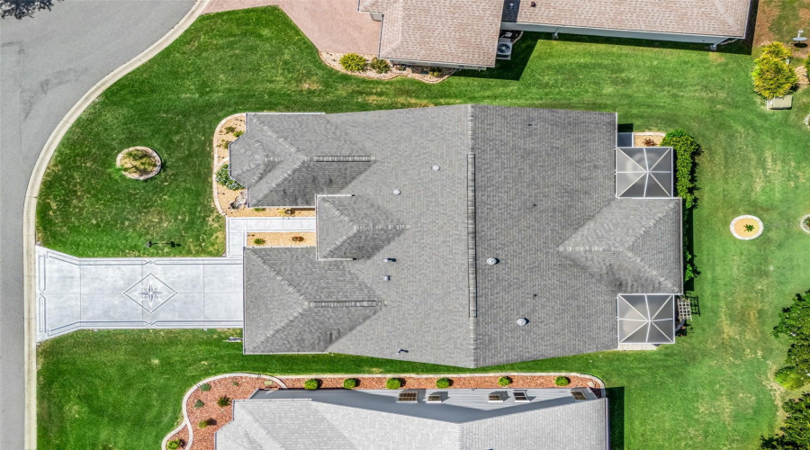 Top-Down Aerial View Showcases The Home’s Roofline, Screened Rear Living Area, Landscaping, And Well-Defined Homesite.