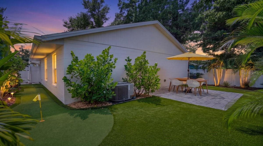 Low Maintenance Artificial Turf With A Putting Green Area For Extra Living Space Or To Entertain Guests!