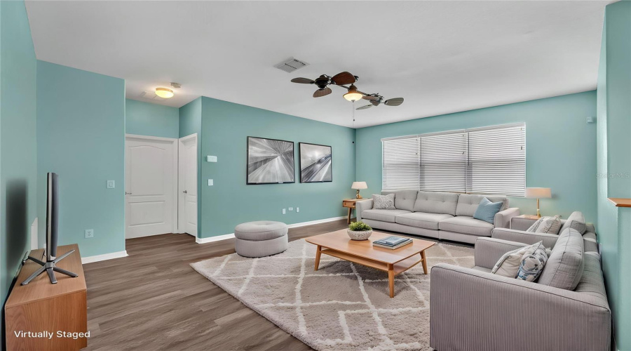 The Spacious Family Room Features Upgraded Vinyl Flooring, Faux Wood Blinds, And Designer Lighting.