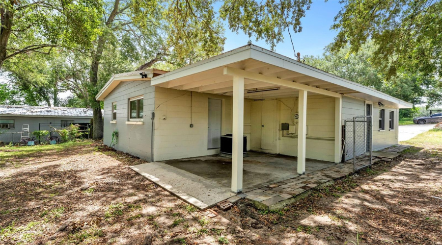 Back Of The Home With A Small Carport
