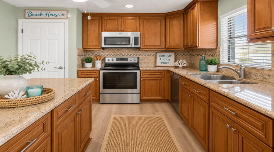 •  Kitchen: Virtually Staged – Coastal-Inspired Kitchen Featuring The Existing Cabinetry, Granite Countertops And Backsplash, With Added Décor,