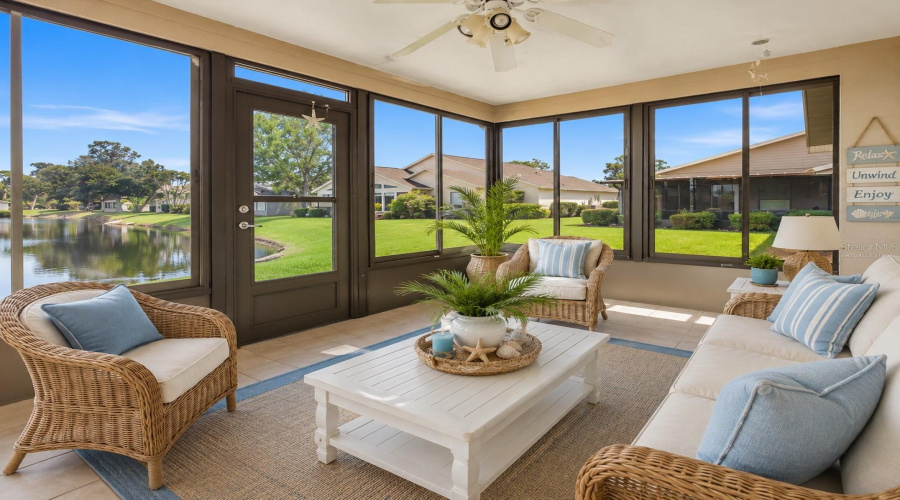 •  Florida Room/Lanai: Virtually Staged – Coastal-Inspired Florida Room Showcasing The Beautiful Water Views And Indoor-Outdoor Florida Lifestyle.