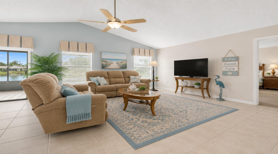 Living Room: Virtually Staged – Spacious Living Room Enhanced With Coastal-Inspired Furnishings, Soft Blue Accents And Comfortable Seating.