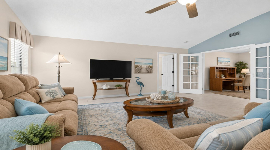 •  Living Room – Alternate View: Virtually Staged – Coastal Décor Highlights The Spacious Living Area, Vaulted Ceiling And Natural Light.