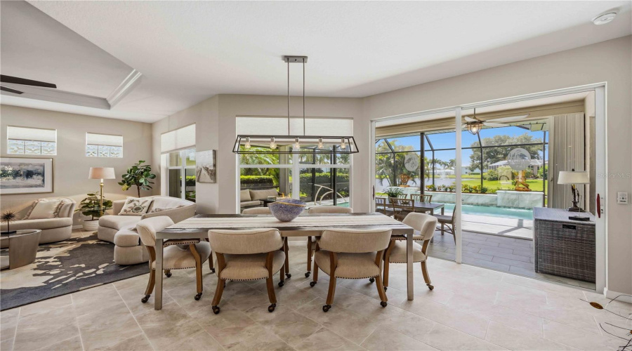 Dinning Room With Sliders Out To The Lanai And Pool
