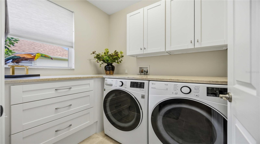 Laundry Space With Cabinets And Granite Countertops