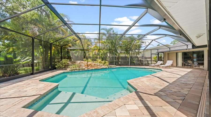 Inviting Pool Under Soaring Screened Cage