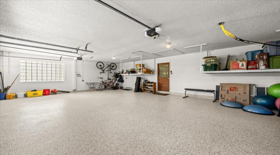 Garage With Storage And Storage Room/Workshop Beyond Door