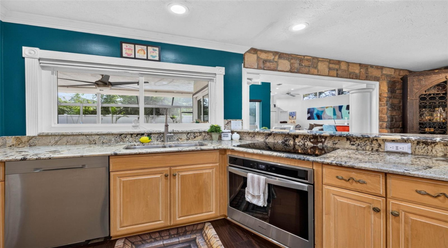Large Window Over The Sink Opens To The Pool Area