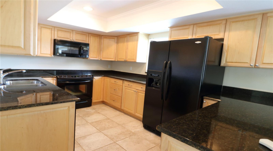 Kitchen With Maple Cabinets &Amp; Granite Counter Surfaces