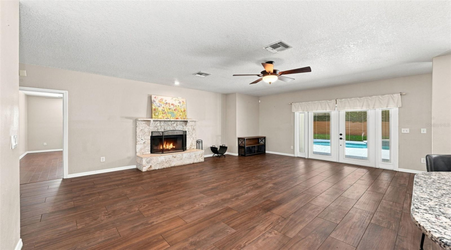 Family Room + Wood Burning Fireplace + French Doors