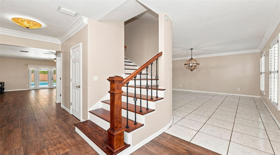 Grand Foyer Staircase With Under Stair Storage + Guest Bath