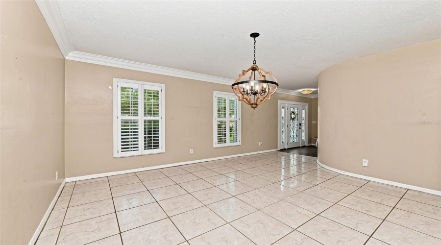 Formal Dining Room With Crown Molding And Plantation Shutters