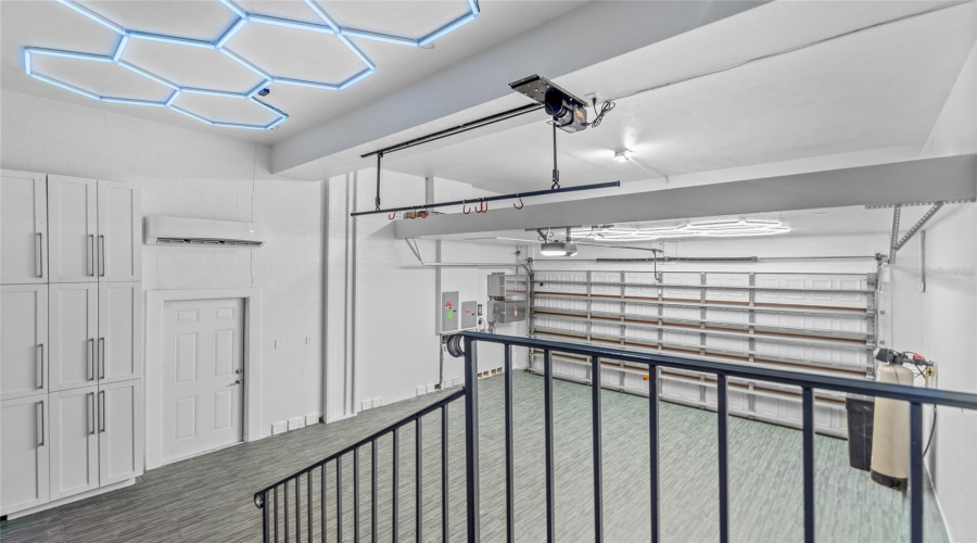 The Two-Car Garage Has Been Retrofitted As A Home Gym, With A Ductless Mini-Split Hvac Wall Unit, Upgraded Lighting, And Softer, Cushioned Flooring.