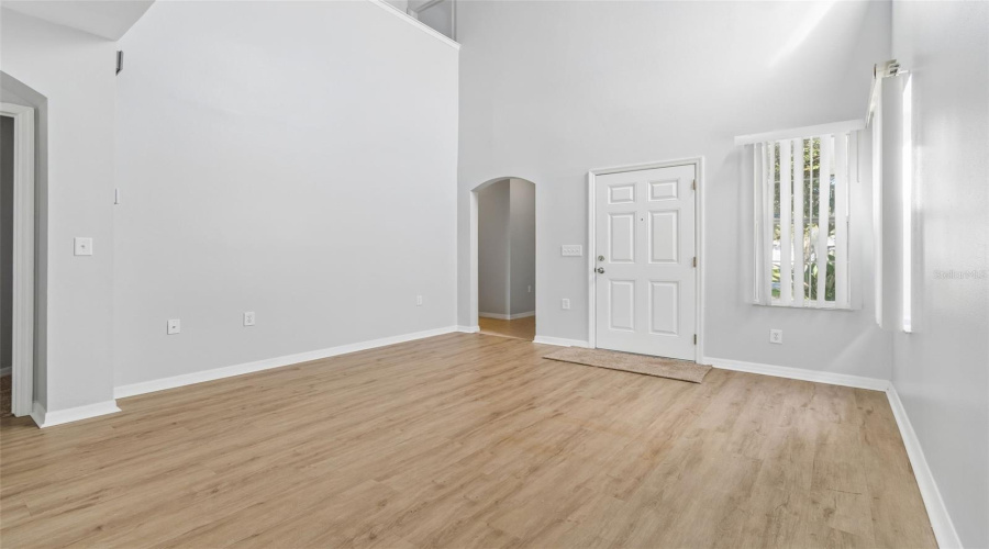 Another View With Opening To Primary Bedroom And Entrance To Garage, Powder Room For Guests And Onto Laundry Room.