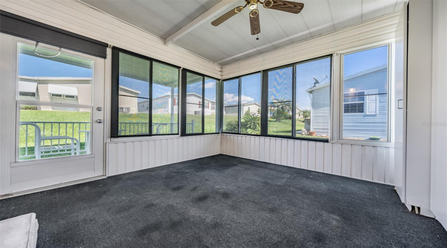 Enclosed Sunroom At The Rear Of The Home With Access To Open Patio