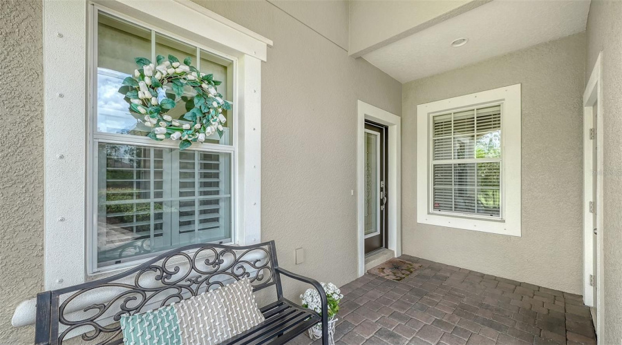 Charming Covered Front Porch And Decorative Impact-Rated Front Door