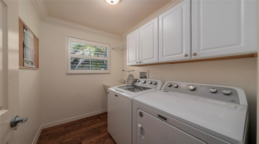 Indoor Laundry Room With Sink And Cabinetry