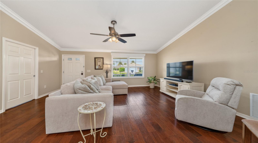 Open Living Area With Engineered Hardwood Flooring And Front Entry View In Sand Dollar Model