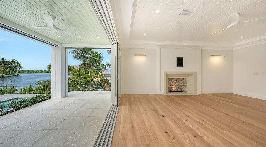 The Walls Of Glass Across The Entire Great Room Open To Covered Porches With Remote Screens