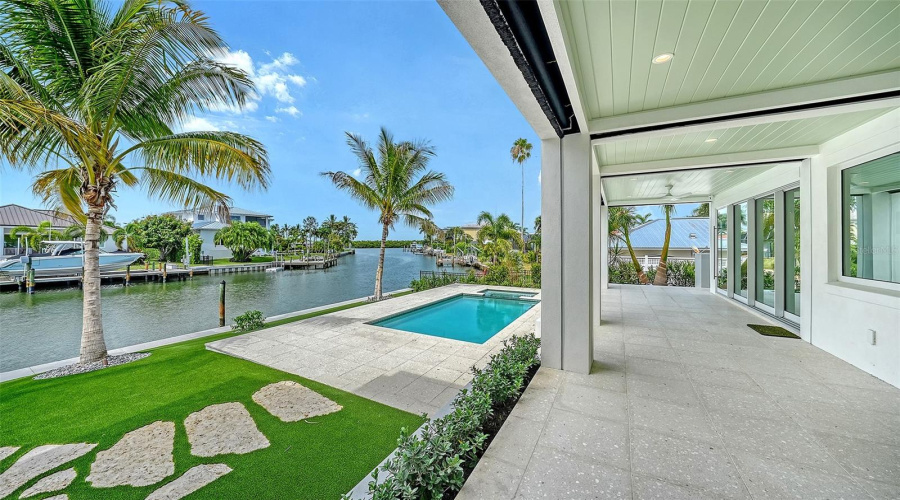 The First Level Porches Extend Across The Whole Great Room And Kitchen And Step Down To The Gorgeous Pool Area