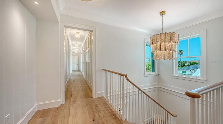 At The Top Of The Staircase With It'S Gorgeous Chandelier, Looking Down The Hall To Two Of The Three Bedrooms Upstairs And The Bonus Room